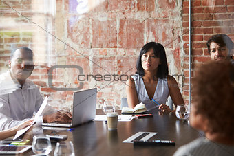 Group Of Businesspeople Meeting In Modern Boardroom