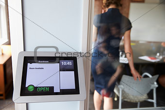 Screen Of Digital Tablet Booking System Outside Modern Boardroom
