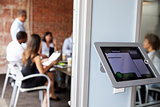 Screen Of Digital Tablet Booking System Outside Modern Boardroom
