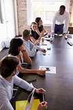 Businesspeople Listening To Presentation In Boardroom
