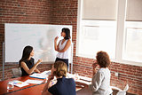 Group Of Businesswomen Meeting In Modern Boardroom