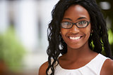 Young black businesswoman wearing glasses, close up