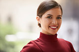 Head and shoulders portrait of young white businesswoman