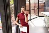 Young white businesswoman on phone looking out office window