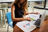 Businesswoman working on documents in office, close up, crop