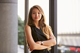 Confident young Asian businesswoman, waist up, close up