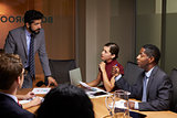 Businessman addressing colleagues at a meeting, close up
