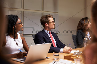 Business colleagues listening at boardroom meeting