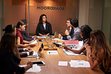 Female boss chairing a business meeting in a boardroom