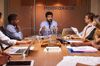 Business people listening to manager at a meeting, close up