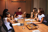 Businesswomen at an evening meeting in a boardroom