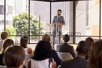 Hispanic man presenting business seminar smiling to audience