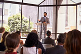 Hispanic man presenting business seminar to audience