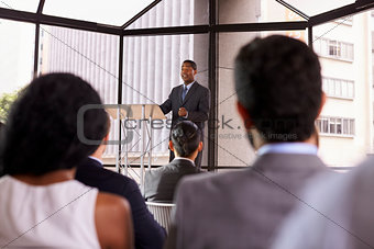 Black businessman presenting business seminar to an audience
