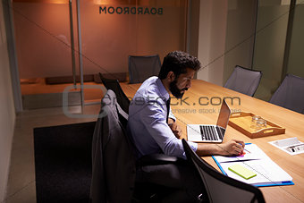 Hispanic businessman working late in office, elevated view