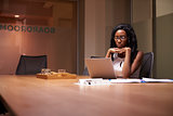 Young black businesswoman working late alone in office