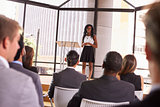 Young black businesswoman presenting seminar to an audience