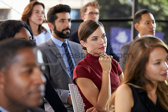 Audience at a business seminar listening to a speaker