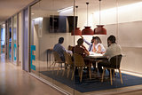Corporate business team using AV display in meeting cubicle