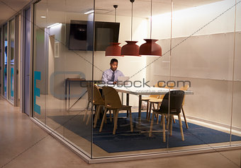 Black businessman working in cubicle at a corporate business