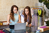 Two young women working in clothing store