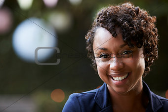 Outdoors Head And Shoulders Portrait Of Smiling Young Woman