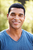 Portrait of smiling young African American man, vertical