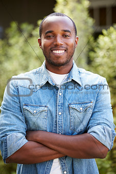 African American man in denim shirt, arms crossed, vertical