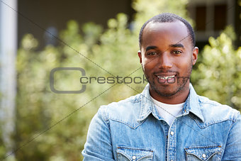 Happy young African American man in denim shirt, horizontal