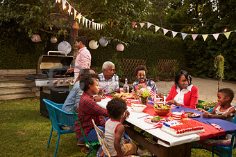 Multi generation black family having a 4th July barbecue