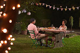 Young black couple relaxing at dinner in a garden