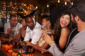 Friends having fun at a Halloween party in a bar