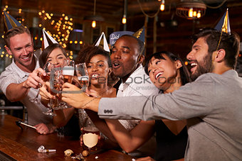 Friends toasting with champagne at New YearÕs party in a bar