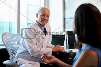 Doctor In Consultation With Female Patient In Office