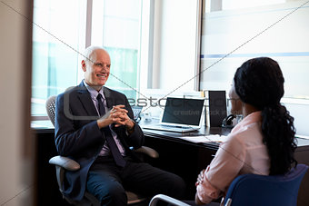 Doctor In Consultation With Female Patient In Office