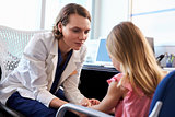 Pediatrician Talking To Unhappy Child In Hospital