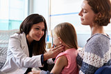 Female Pediatrician Examining Child In Hospital
