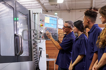 Engineer Training Apprentices On CNC Machine