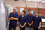 Portrait Of Engineer Training Apprentices On CNC Machine