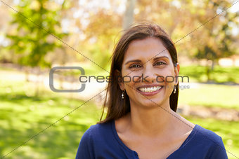 Mixed race Asian Caucasian woman in park looking to camera