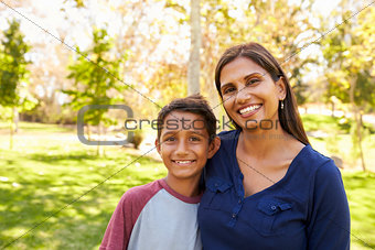 Mixed race Asian Caucasian mother and son in park, portrait