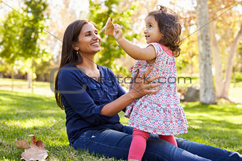Asian Caucasian mixed race mother and young daughter in park