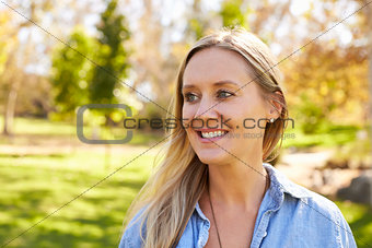 Mid thirties white woman looking away from camera in park