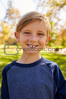 Seven year old Caucasian boy in a park, vertical portrait