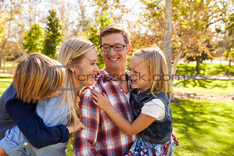 Young white family having fun together in a park