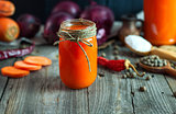 Fresh carrot juice in a glass jar 