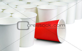 Red paper cup among white caps.
