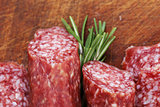 salami sausage with rosemary on a wooden board