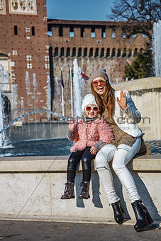 mother and daughter near Sforza Castle in Milan handwaving