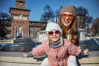 mother and daughter tourists in Milan, Italy having fun time